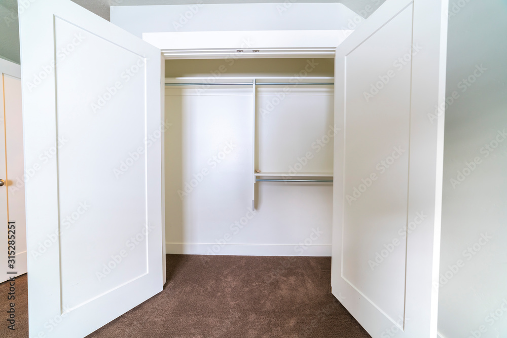 Empty interior of an open white closet Empty interior of an open white closet
