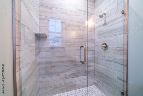 Large modern tiled shower cubicle bright interior