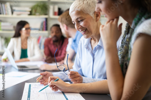 Successful group of business people at work in office © NDABCREATIVITY