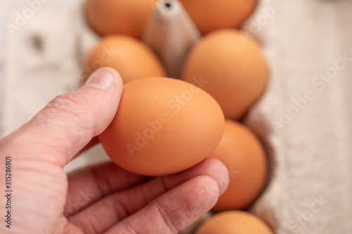 Egg on hand and eggs background for cooking soft focus. © Olya