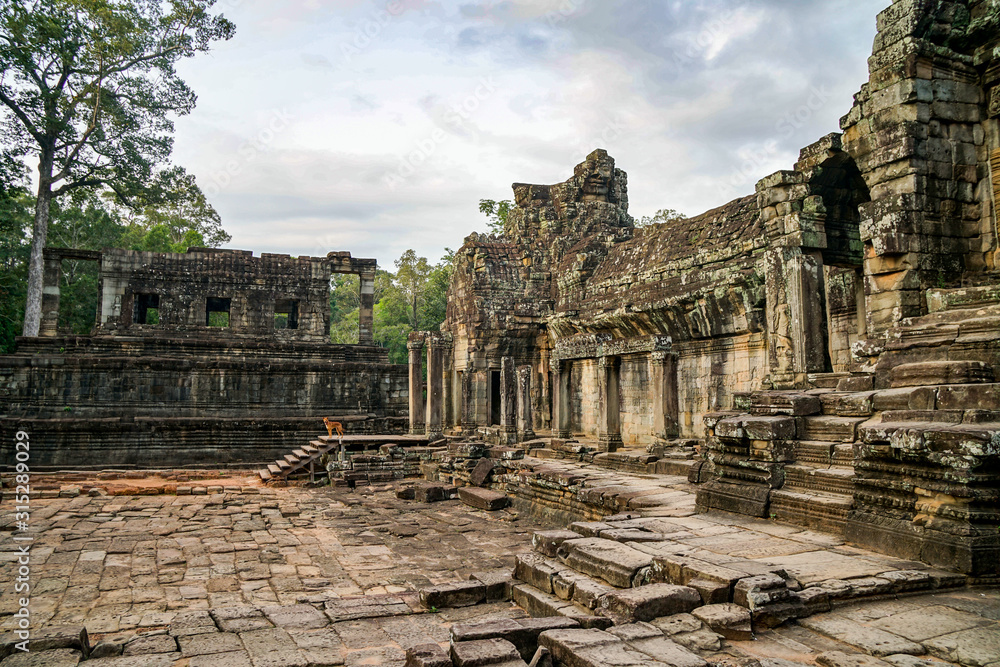 the ruined wreck of the Angkor Wat complex, sunny day, street territory and ruins, ancient steps and walls