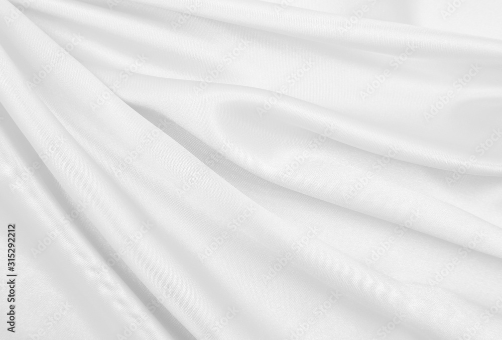 Smooth elegant white silk or satin luxury cloth texture as wedding background. Luxurious background design