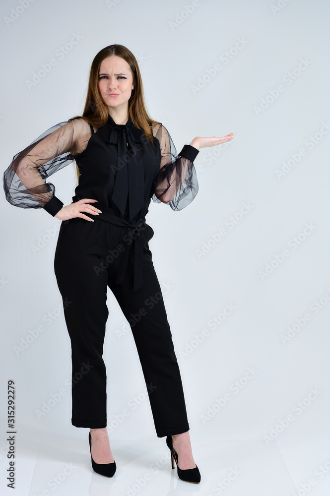 A full-length photo of a pretty smiling girl A brunette girl with excellent makeup in dark clothes is standing on a white background, talking with emotions. Concept portrait for a banner. A full-length photo of a pretty smiling girl A brunette girl with excellent makeup in dark clothes is standing on a white background, talking with emotions. Concept portrait for a banner.