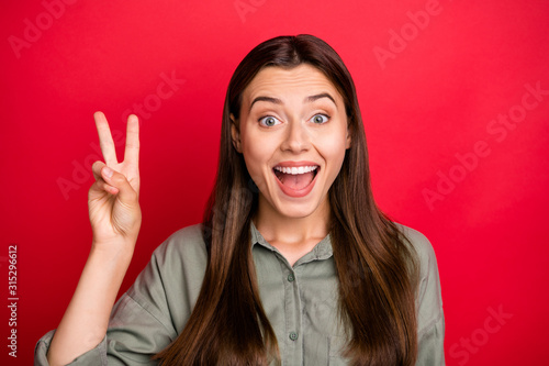 Close-up portrait of her she nice attractive lovely crazy ecstatic cheerful cheery straight-haired girl showing v-sign having fun isolated over bright vivid shine vibrant red color background