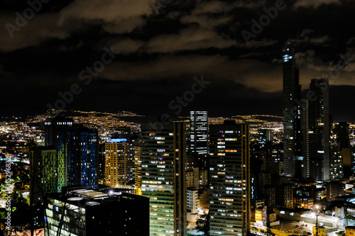 View of the night city with high buildings. Bogota  Colombia. A bit cloudy.