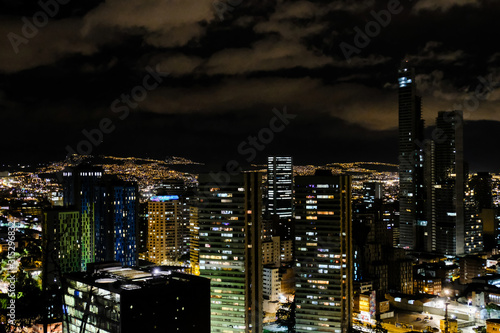 View of the night city with high buildings. Bogota, Colombia. A bit cloudy.