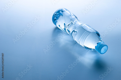 Plastic bottle lay down on white background.