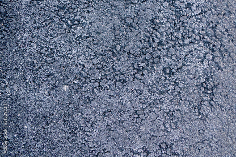 texture of the frozen asphalt. frost on the asphalt as a background