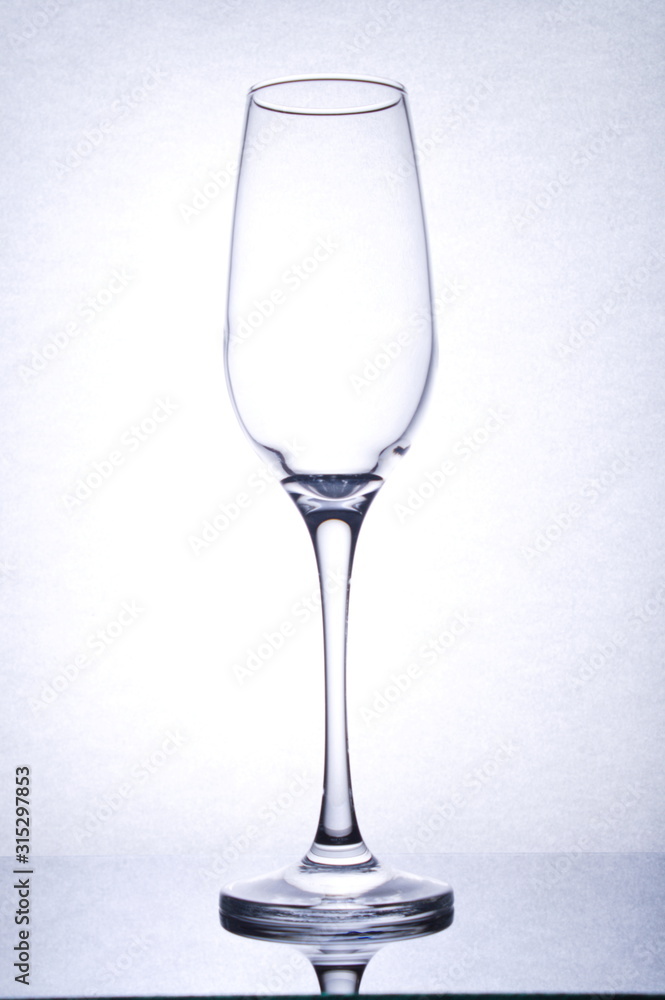 isolated emty glass goblet, on mirror surface, backlight, portrait orientation isolated emty glass goblet, on mirror surface, backlight, portrait orientation