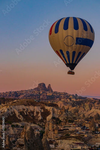 Hot air balloon on the background of the city of Goreme in Turkey