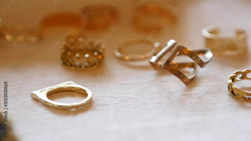 Designer gold hand ring placed on table, Fashionable jewelry for models Designer gold hand ring placed on table, Fashionable jewelry for models