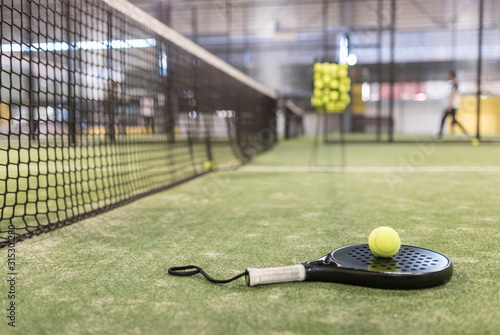 paddle tennis racket and balls in court © FotoAndalucia