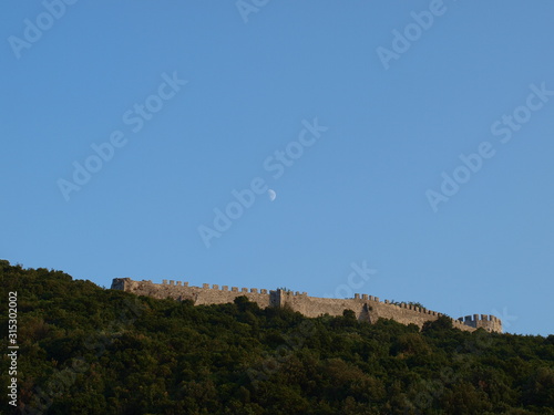 Castle walls on top of a green hill