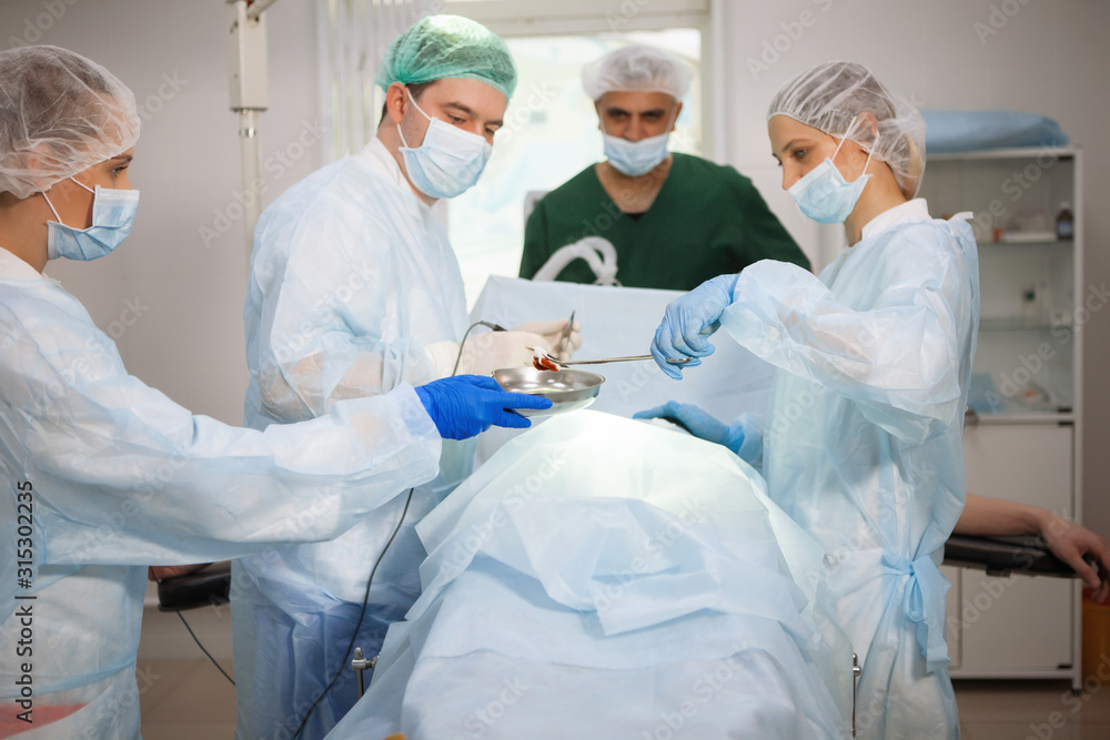 Team of surgeons doing surgery Team of surgeons doing surgery