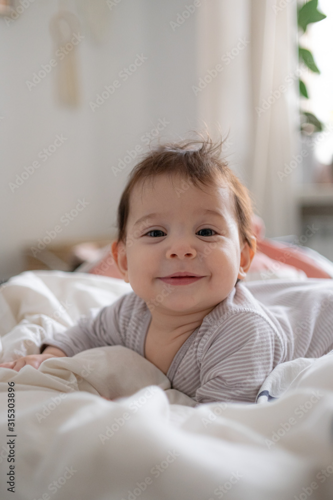 Little cute infant baby portrait in gender neutral clothes smiling Little cute infant baby portrait in gender neutral clothes smiling