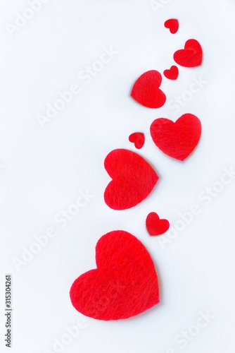 Red felt hearts on a white background. Valentine s day symbol  holiday concept. Top view with copy space for text.