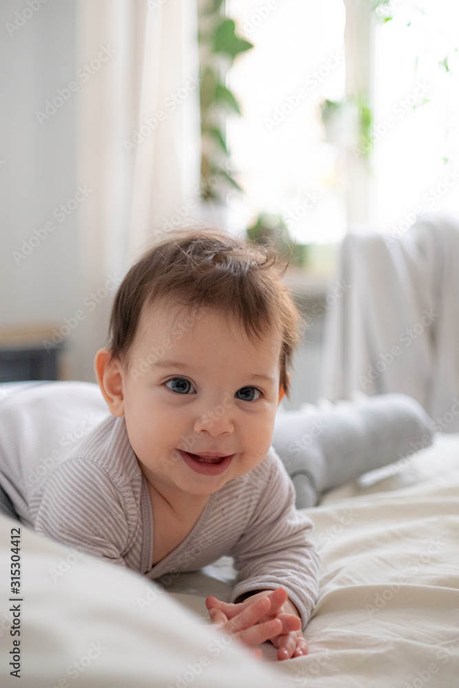 Little cute infant baby portrait in gender neutral clothes smiling Little cute infant baby portrait in gender neutral clothes smiling