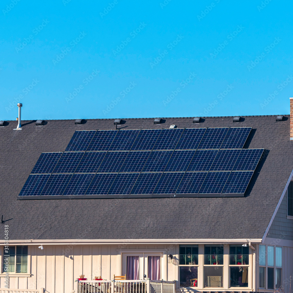 Square Urban house with solar panels on the roof Square Urban house with solar panels on the roof