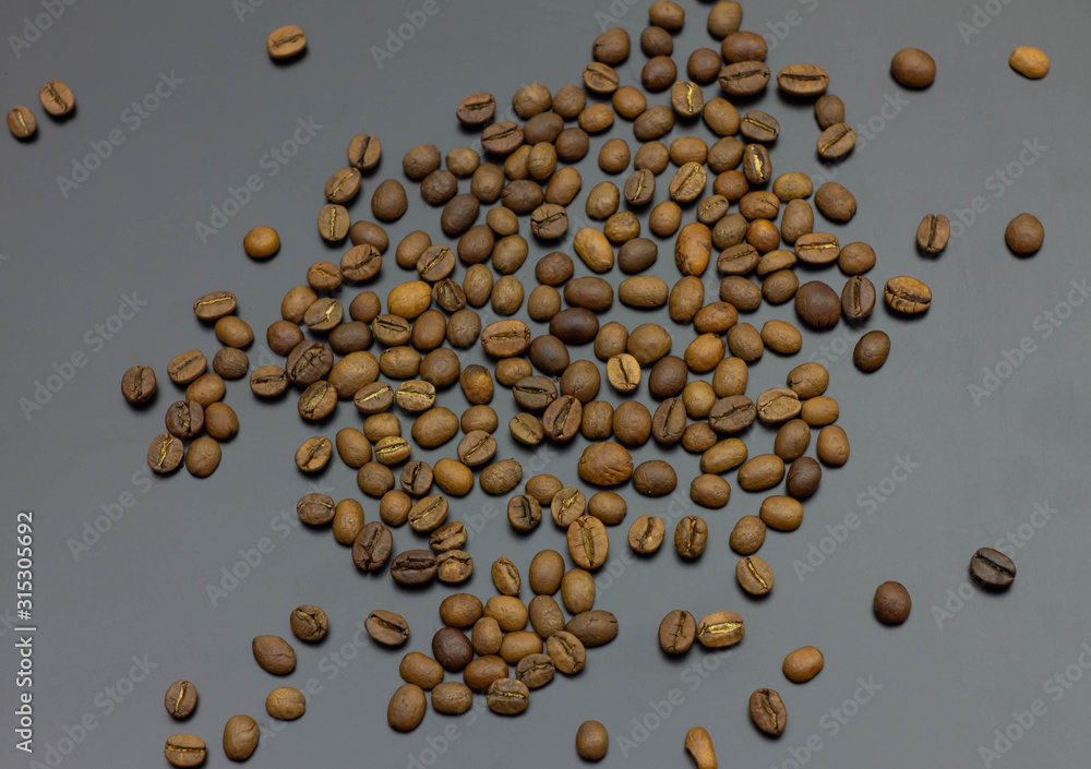 pile of coffee beans isolated on gray background pile of coffee beans isolated on gray background