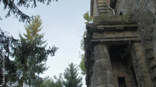Old fortress in the forest abandoned brick mansion house ruined facade exterior 16th century Palace of Earl Xido in Khmelnik Ukraine photo