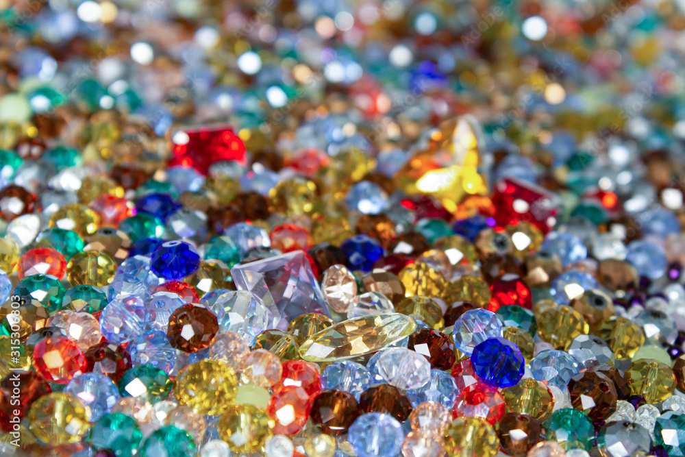 Mix of shining colorful faceted glass beads and cristals. Selective fokus. Mix of shining colorful faceted glass beads and cristals. Selective fokus.