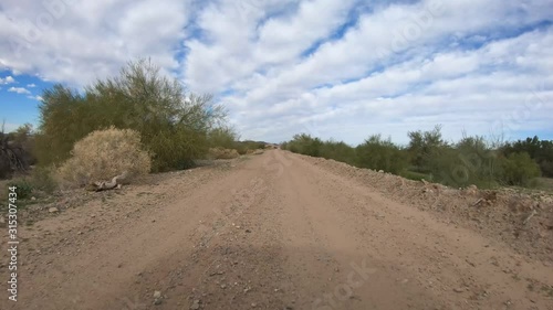 POV driving down a gravel road in the desert - Yuma, Arizona