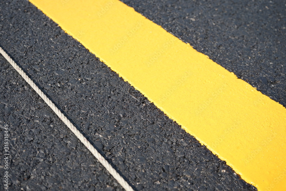 Fototapeta premium Yellow traffic line After completing the construction