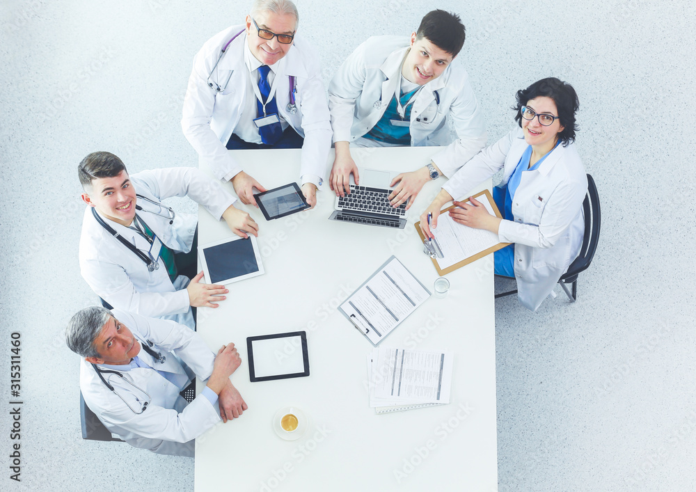 Fototapeta premium Medical team sitting and discussing at table, top view