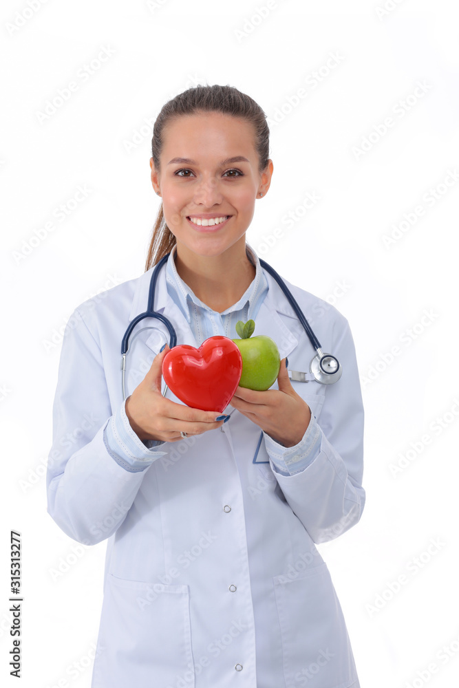 Beautiful smiling female doctor holding red heart and green apple. Woman doctor Beautiful smiling female doctor holding red heart and green apple. Woman doctor