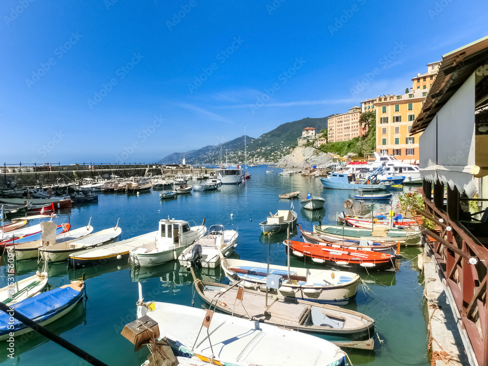 Colorful buildings and beach at Camogli on sunny summer day, Lig