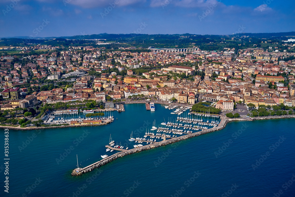 Aerial view of the city center of Desenzano del Garda, Italy. The main lighthouse of the city, boat parking in the city center.