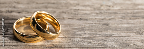 Golden wedding rings on wood photo