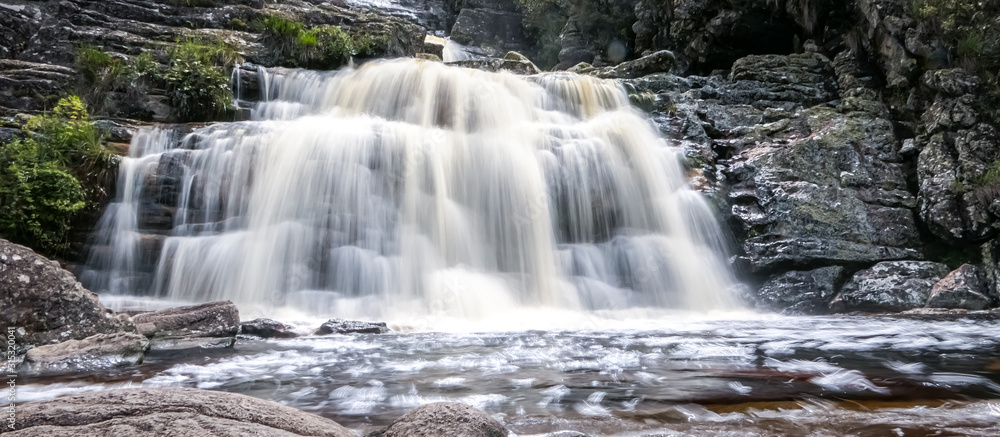Close up of a beautiful waterfall with water motion blur and pond, Caraca natural park, Minas Gerais, Brazil Close up of a beautiful waterfall with water motion blur and pond, Caraca natural park, Minas Gerais, Brazil