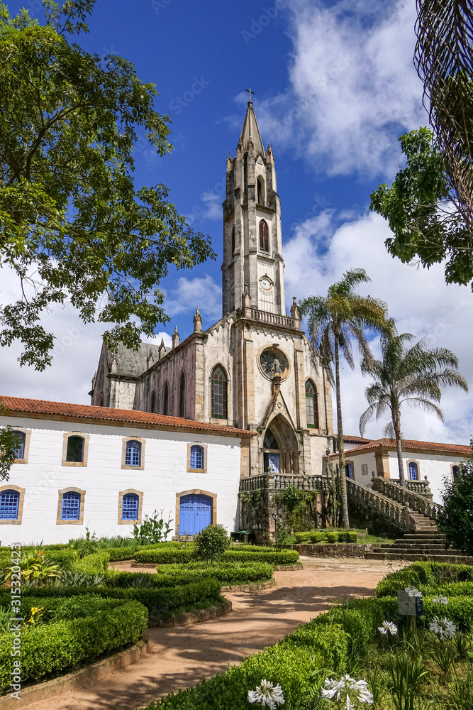 View to church and buildings with blue sky and white clouds, Sanctuary Caraça, Minas Gerais, Brazil View to church and buildings with blue sky and white clouds, Sanctuary Caraça, Minas Gerais, Brazil