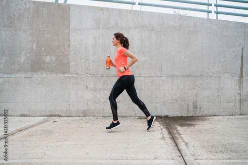 Portrait of fitness woman running. © Mego-studio