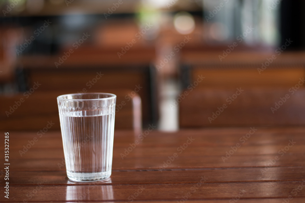Pure water glass on old wooden table Pure water glass on old wooden table
