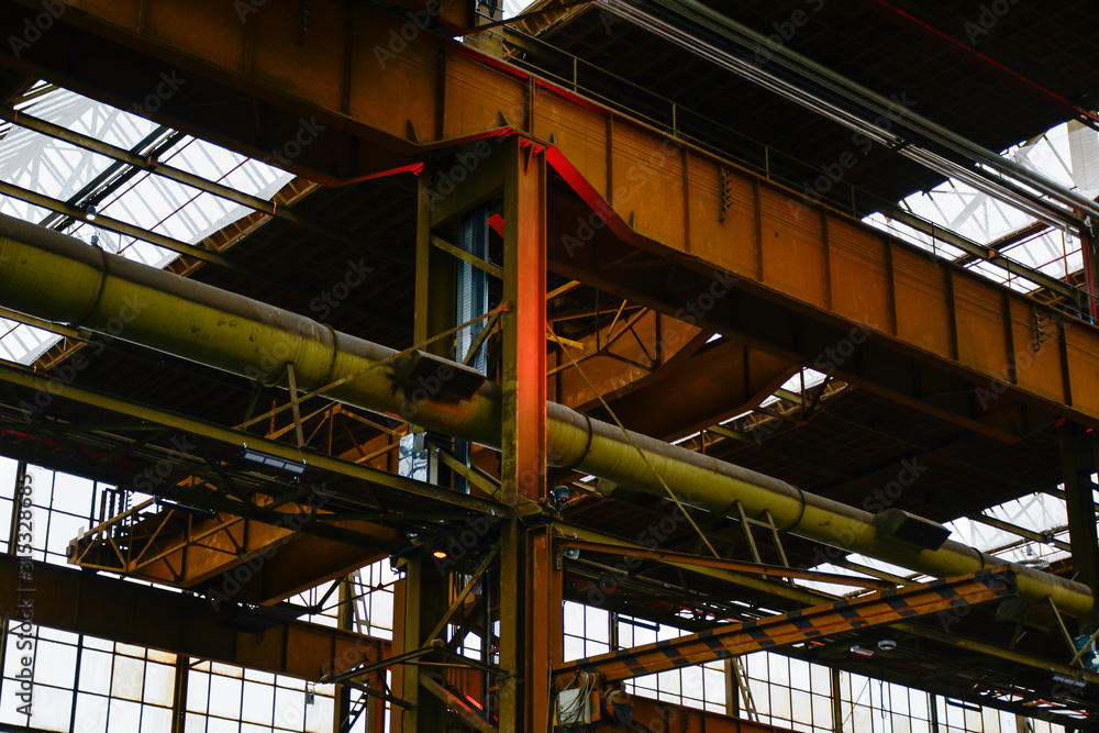 Fototapeta premium Industrial interior of an old rusty factory building