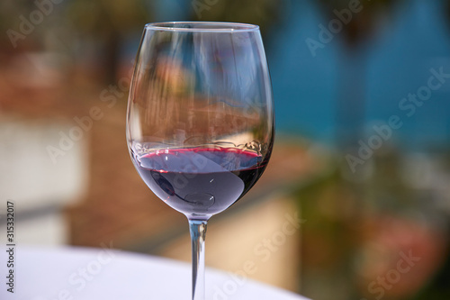 glass of red wine near sea