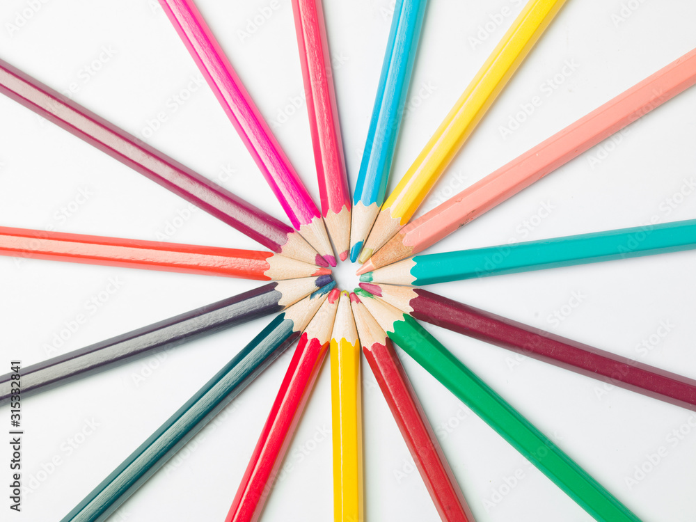 various colors of pencils on a white background, copy space