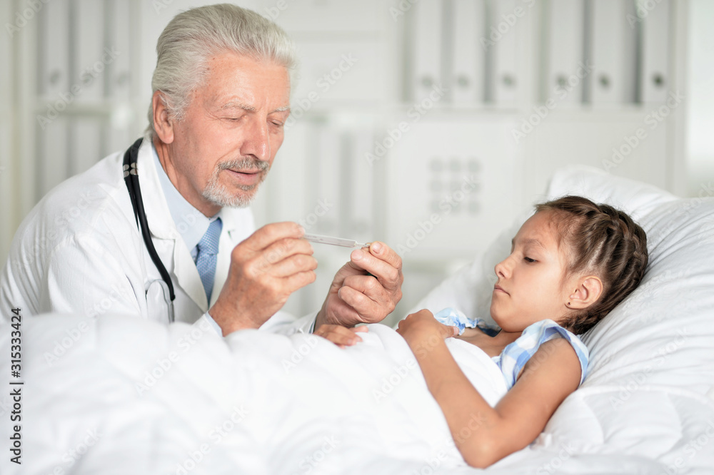 Fototapeta premium Portrait of man doctor and girl in hospital