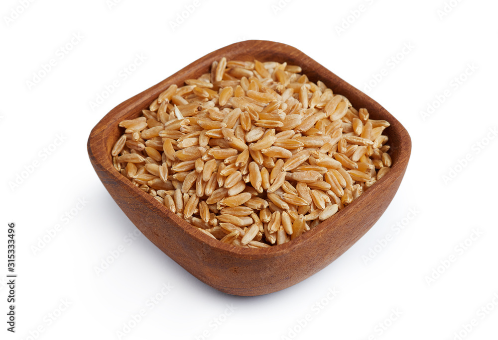 Khorasan wheat or kamut (Triticum turgidum) in wooden bowl isolated on white background