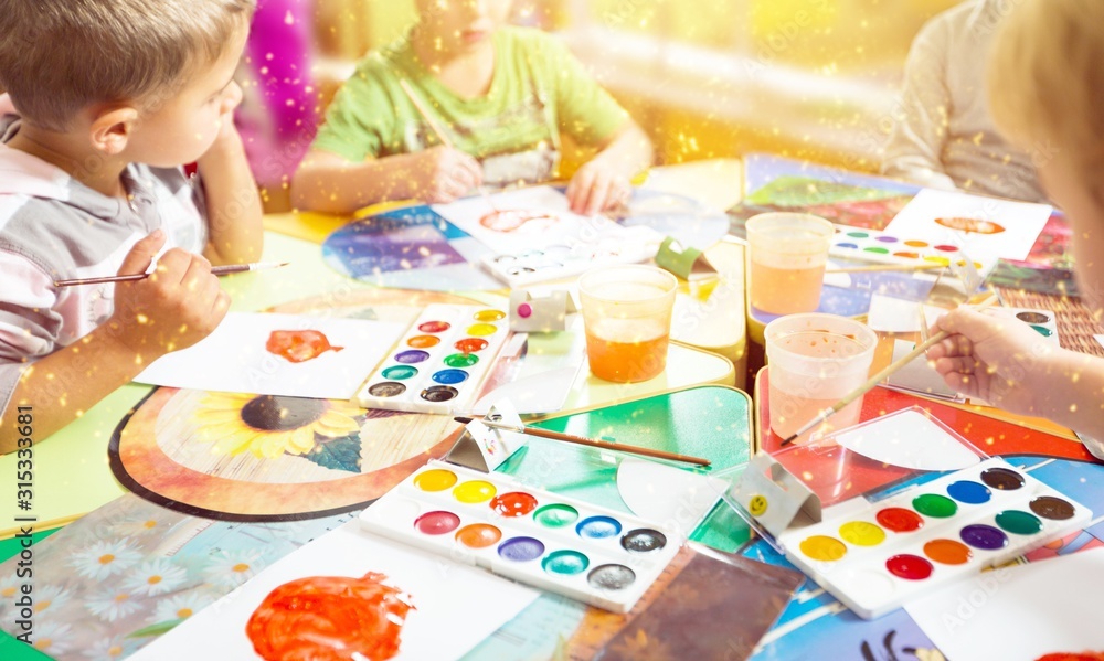 Little children with colorful painted hands on class background Little children with colorful painted hands on class background