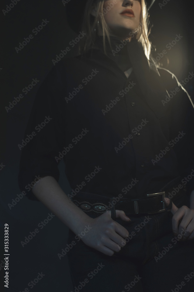 Blonde cowgirl in black shirt and hat. Blonde cowgirl in black shirt and hat.
