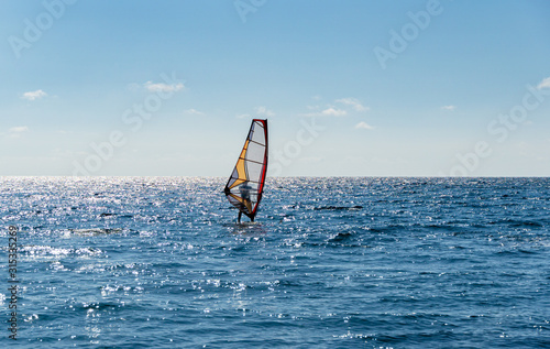Beautiful view of windsurfer sailing on the waves. Windsurfing on the Black Sea. Yalta, Crimea.