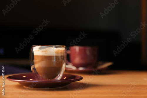 Aromatic coffee on wooden table in cafe. Space for text