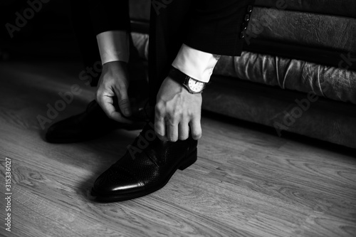 Man ties laces on his shoes