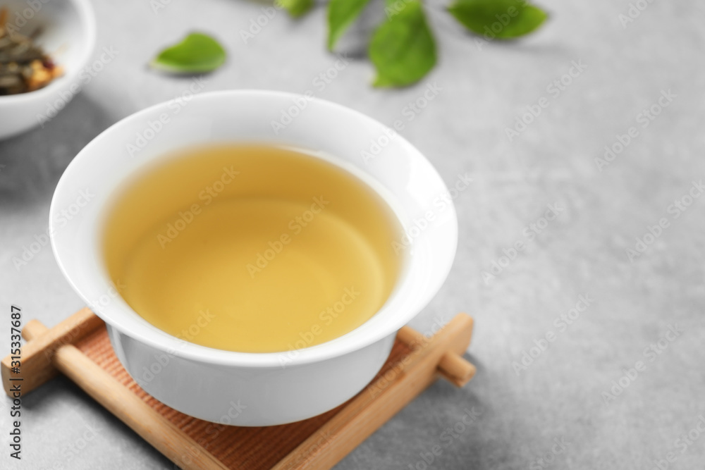 Cup of green tea on grey table Cup of green tea on grey table