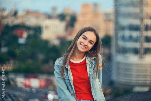 Lovely teen girl on cityscape background