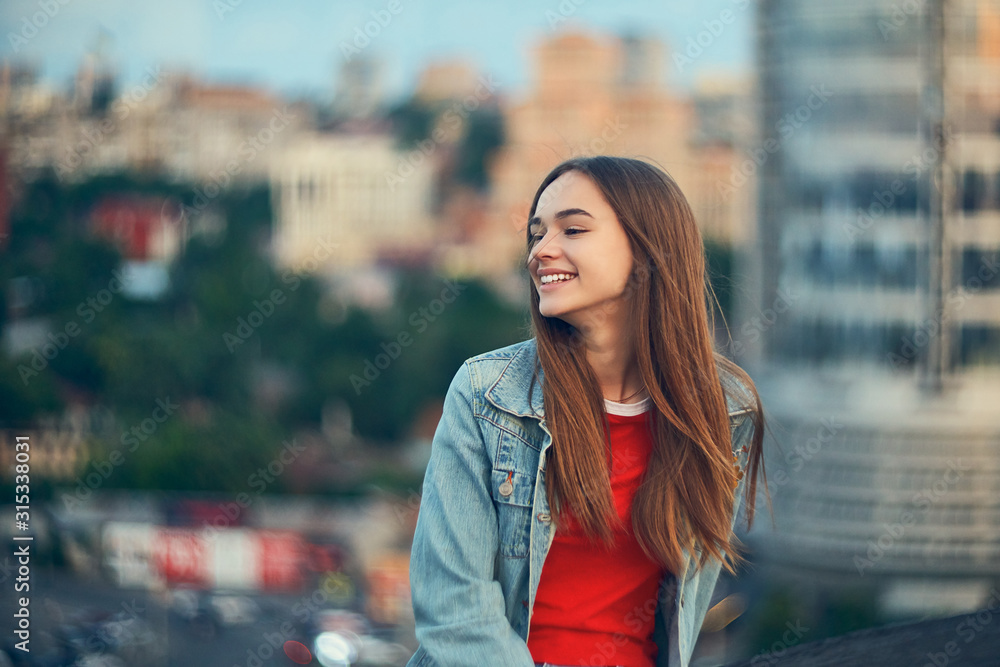 Lovely teen girl on cityscape background