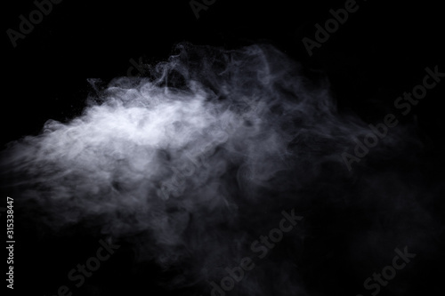 Jet of smoke on black background. Selective focus